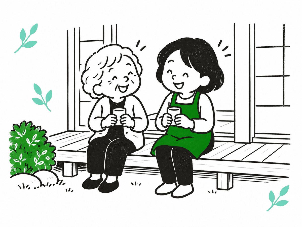 縁側で並んでお茶を飲みながら笑い合う絵